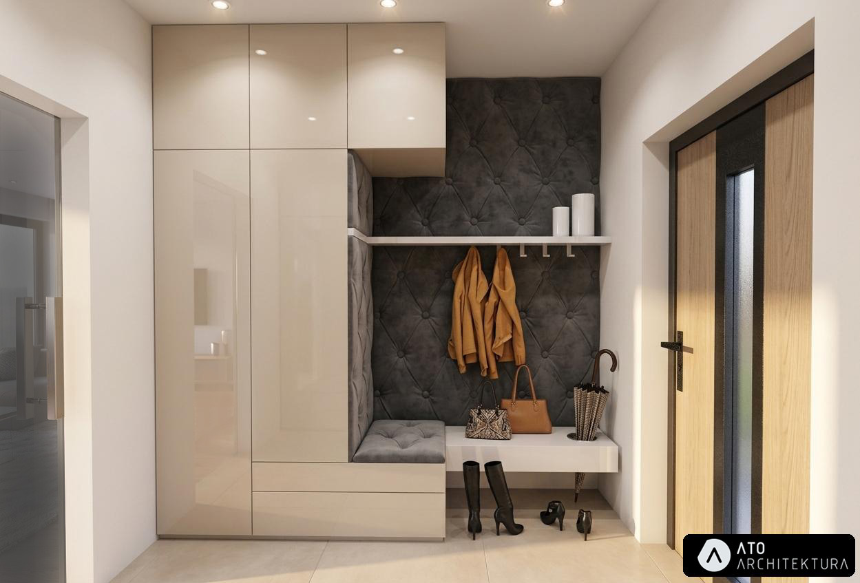 Nowoczesny przedpokój z szafą w zabudowie, tapicerowanym siedziskiem i wieszakami. Uwagę zwraca pikowana ściana w kolorze grafitowym i eleganckie dodatki.