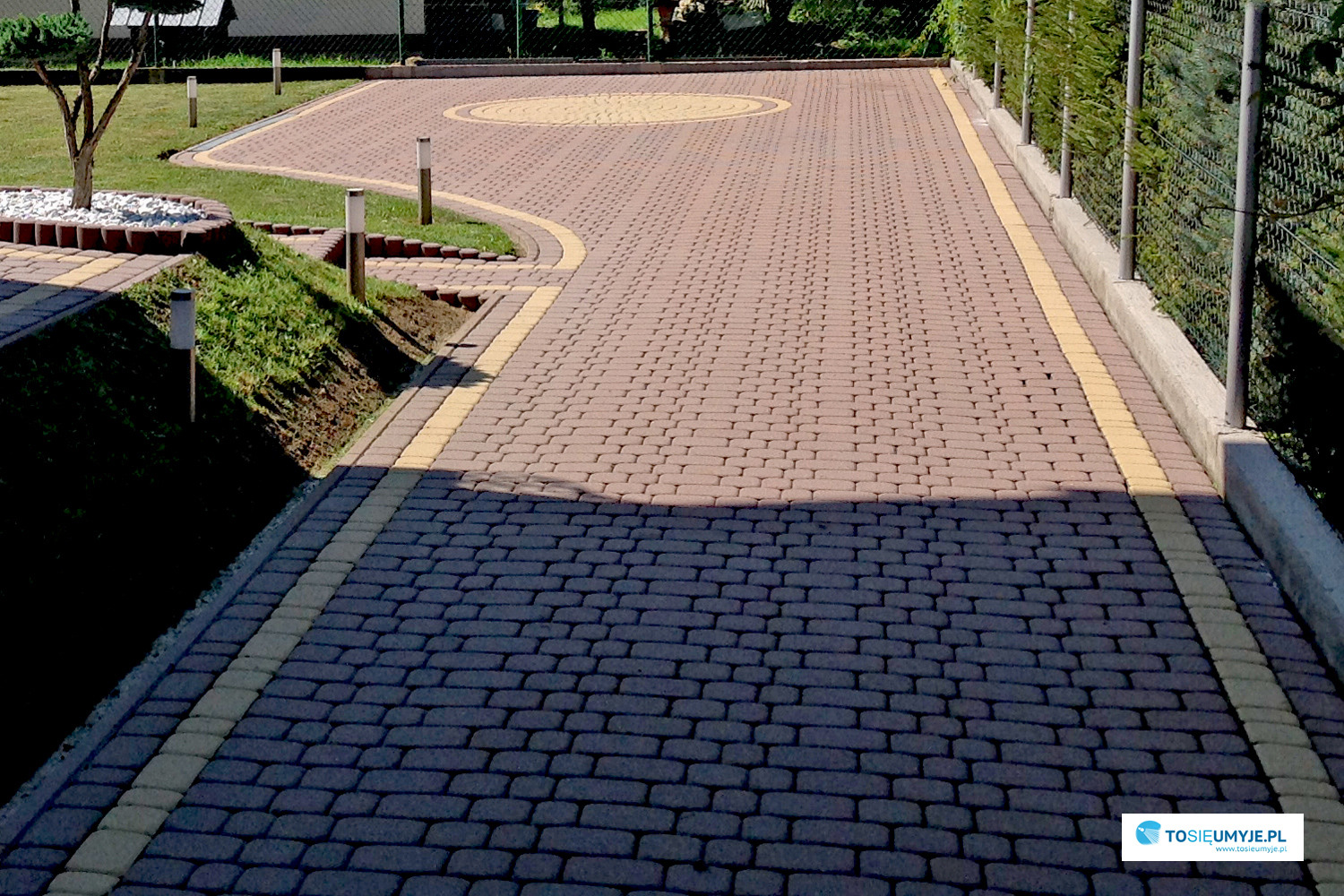 Ułożona kostka brukowa w dwóch odcieniach brązu i żółtym obramowaniem, tworząca wzór na podjeździe i ścieżkach ogrodowych.