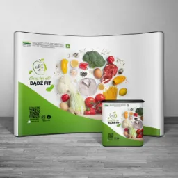 Stoisko reklamowe z grafiką promującą zdrowy tryb życia i odżywianie, prezentowane w Rzeszowie, z widocznymi warzywami, owocami i produktami spożywczymi na białym tle.