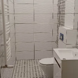 Nowoczesna łazienka z białymi płytkami o falistej strukturze na ścianach, wzorzystą podłogą w krzyżyki, białym grzejnikiem drabinkowym i umywalką z szafką.