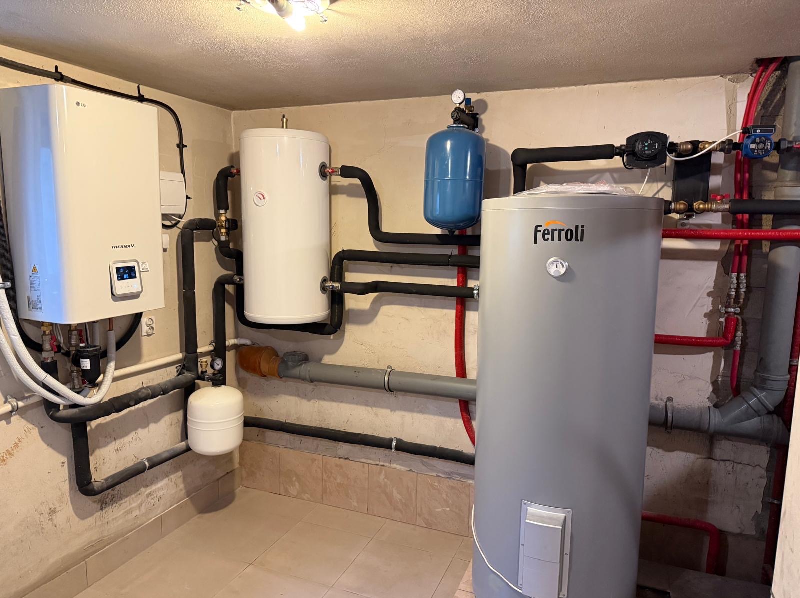 Kompletna instalacja grzewcza z pompą ciepła LG Therma V, zbiornikami i osprzętem Ferroli w kotłowni z wykończonymi ścianami i podłogą.