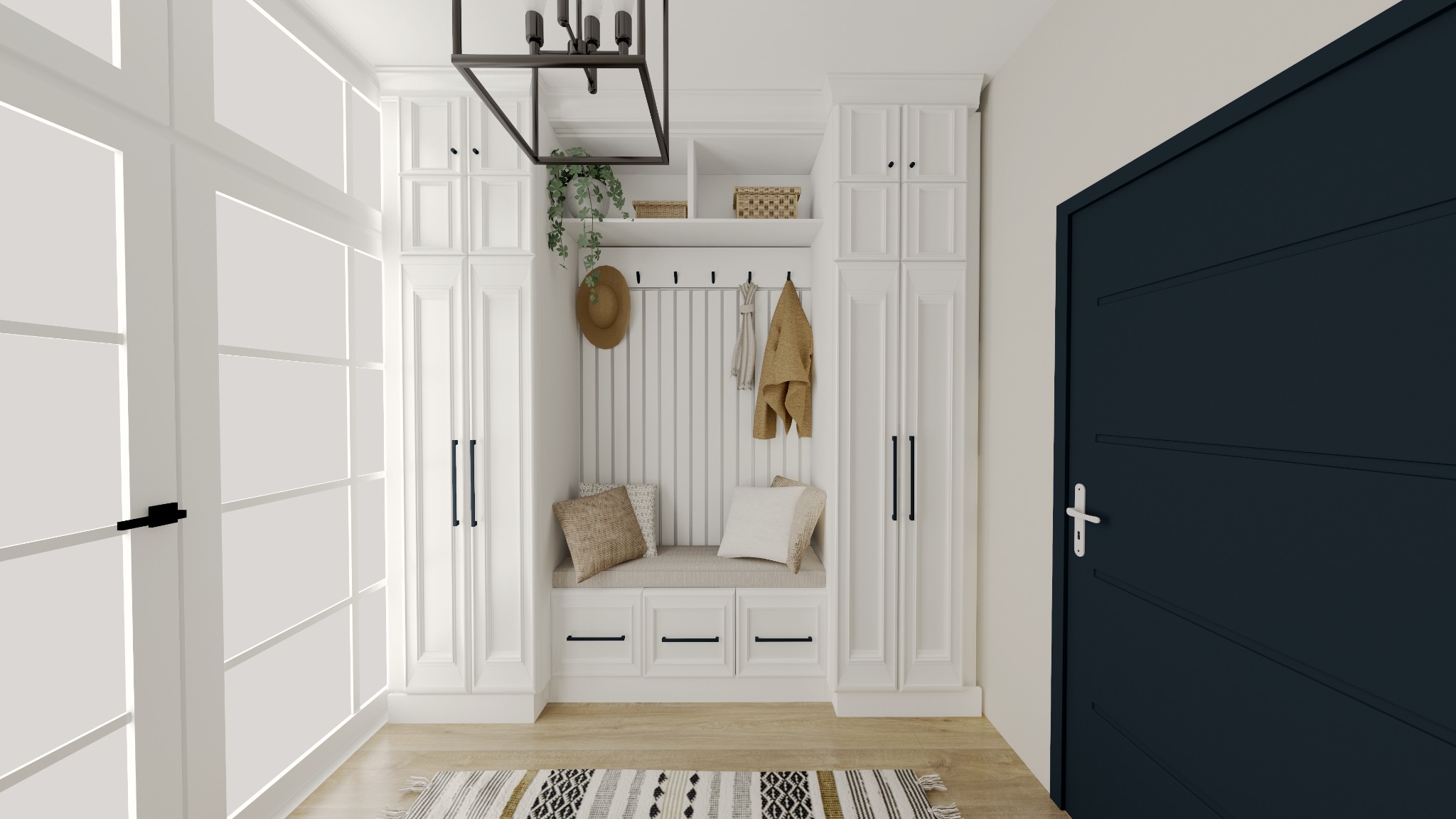 Biała zabudowa przedpokoju z siedziskiem, wieszakami i szafkami, uzupełniona o dekoracje jak kapelusz, roślina i dywanik. Ciemne drzwi po prawej.