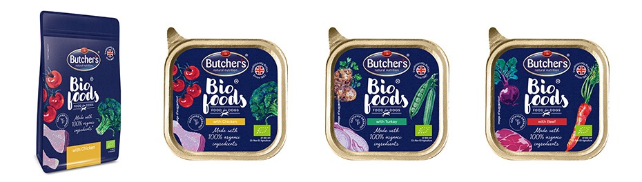 Różne opakowania karmy dla psów marki Butcher's Bio Foods, w tym saszetka i trzy tacki z różnymi smakami: kurczak, indyk i wołowina, z wyraźnie widocznymi ilustracjami warzyw i mięsa.