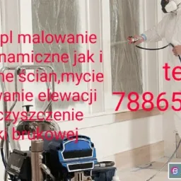 Pracownik w kombinezonie ochronnym, z maską na twarzy, maluje ścianę natryskowo za pomocą profesjonalnego agregatu malarskiego; ściana zabezpieczona folią malarską; widoczne reklamy firmy i numer...