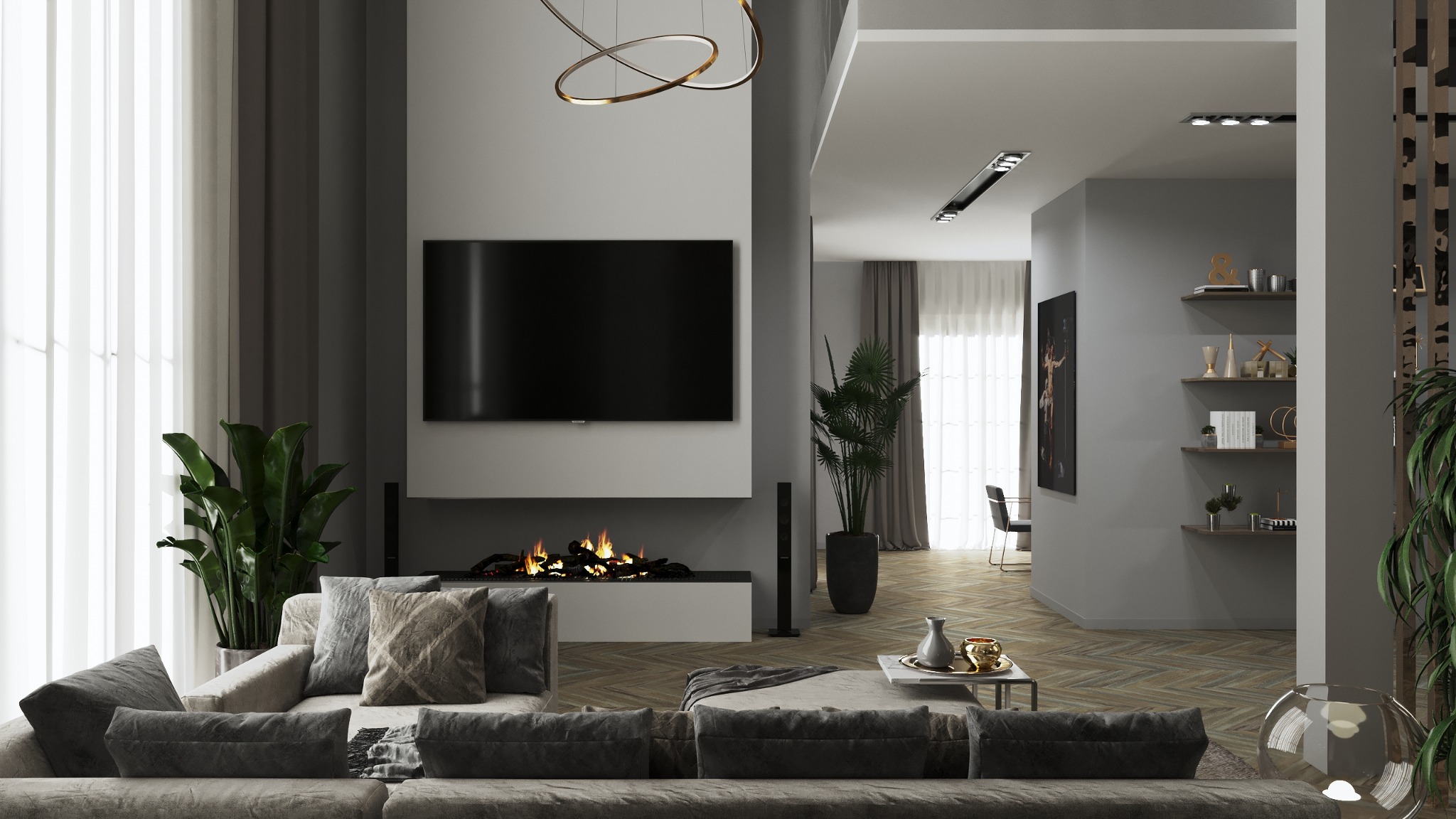 Nowoczesny salon z kominkiem elektrycznym pod wiszącym telewizorem, szarą sofą z poduszkami i roślinami w donicach, oświetlony lampą pierścieniową, z widokiem na jadalnię z półkami i obrazem...