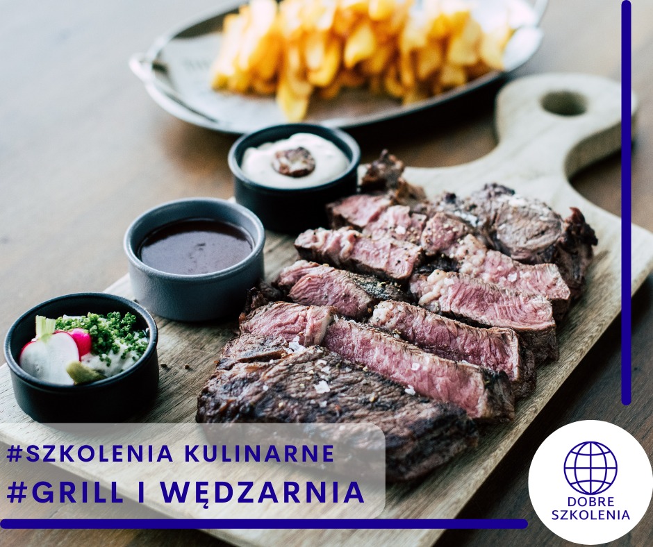 Krojony stek na drewnianej desce z trzema sosami w czarnych miseczkach i frytkami w tle, ujęcie z góry.