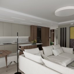 A BEŚKA DESIGN Anna Beśka - Wizualizacja przestronnego wnętrza mieszkania z otwartą kuchnią, jadalnią i salonem, z dominującą kolorystyką beżu, brązu i bieli, oświetlonego nowoczesnymi lampami sufitowymi i z dużym obrazem...
