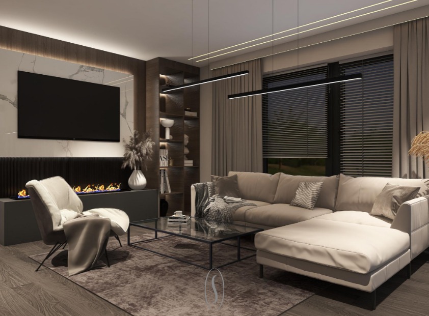 Elegancki salon z narożną sofą w odcieniach beżu, nowoczesnym kominkiem z płomieniami, szklanym stolikiem kawowym, dekoracyjnymi lampami wiszącymi i marmurową ścianą z telewizorem.