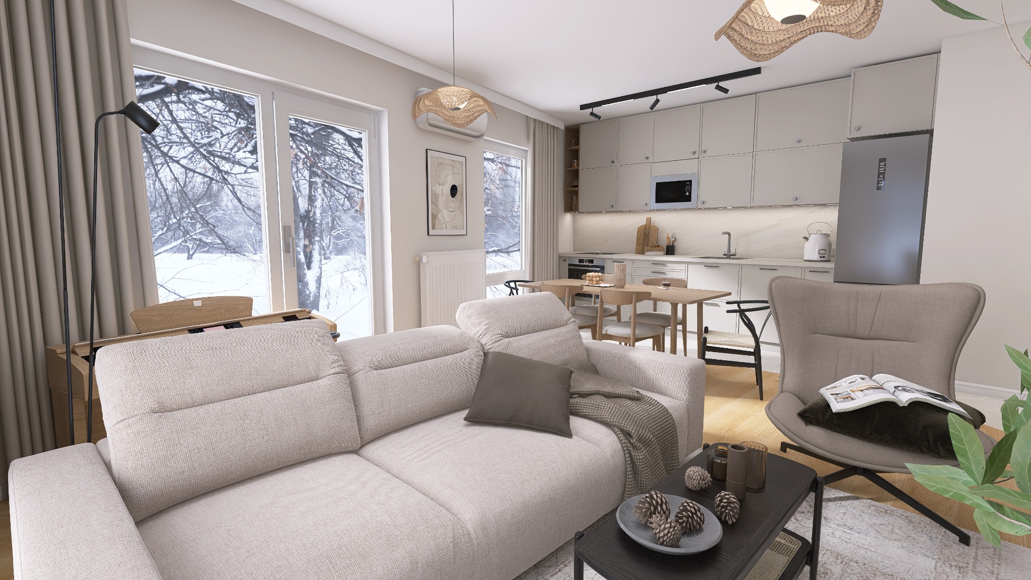 Jasne, przestronne wnętrze mieszkania z widokiem na zimowy krajobraz za oknem, beżowa sofa z poduszką i pledem, stolik kawowy z dekoracjami, krzesło z książką, otwarta kuchnia z jadalnią w tle.