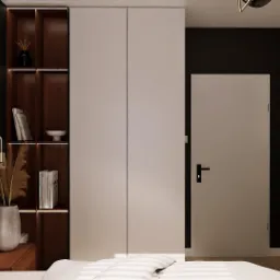 Nowoczesna sypialnia z minimalistyczną szafą wnękową z oświetleniem LED, dekoracyjnym wazonem z trawą pampasową na szafce nocnej i obrazem z motywem roślinnym na ścianie.