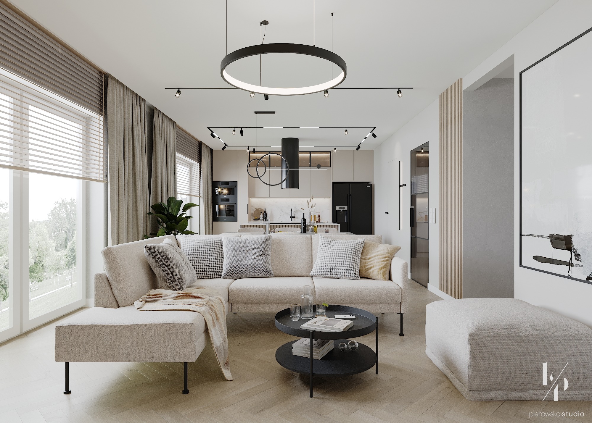 Jasny salon z narożną sofą, okrągłym stolikiem kawowym i otwartą kuchnią w tle. Na podłodze parkiet w jodełkę, a nad sofą okrągła lampa sufitowa.