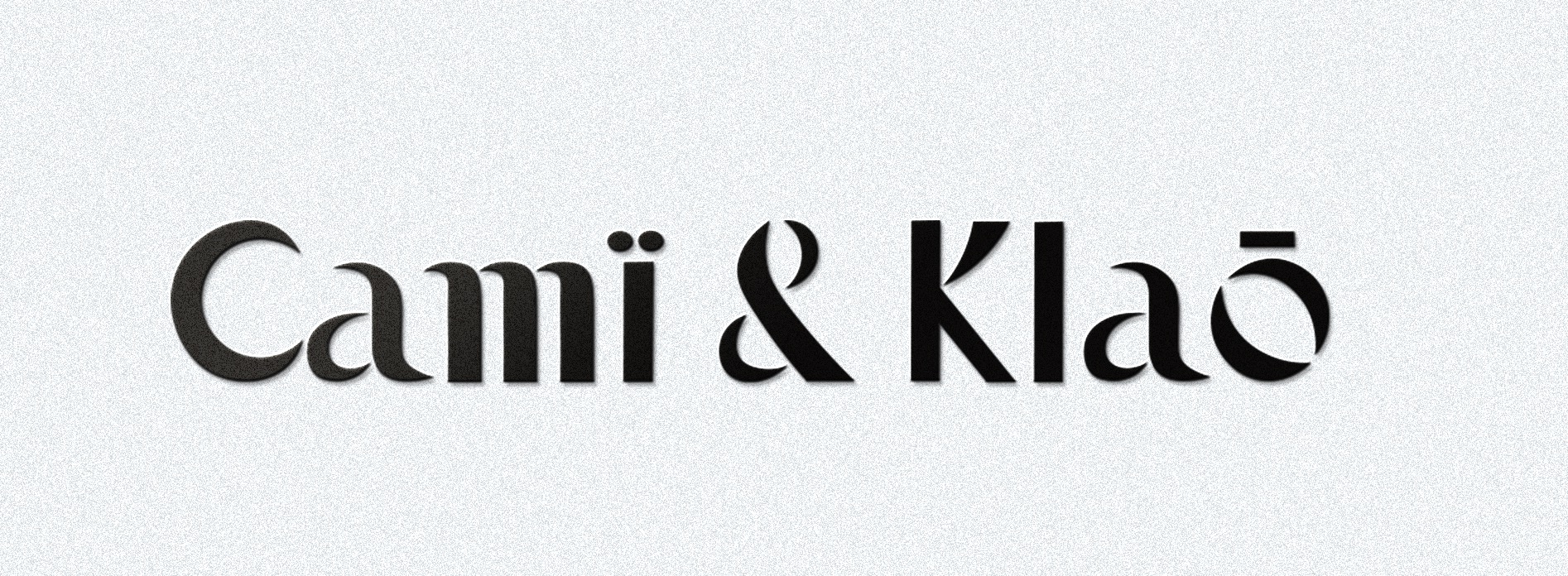 Minimalistyczne logo 'Cami & Klao' w czarnej, teksturowanej czcionce na jasnoszarym, szorstkim tle.