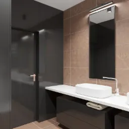 Nowoczesna łazienka z brązowymi płytkami imitującymi kamień, czarnymi frontami szafek pod umywalkami, owalną umywalką nablatową i podświetlanym lustrem.