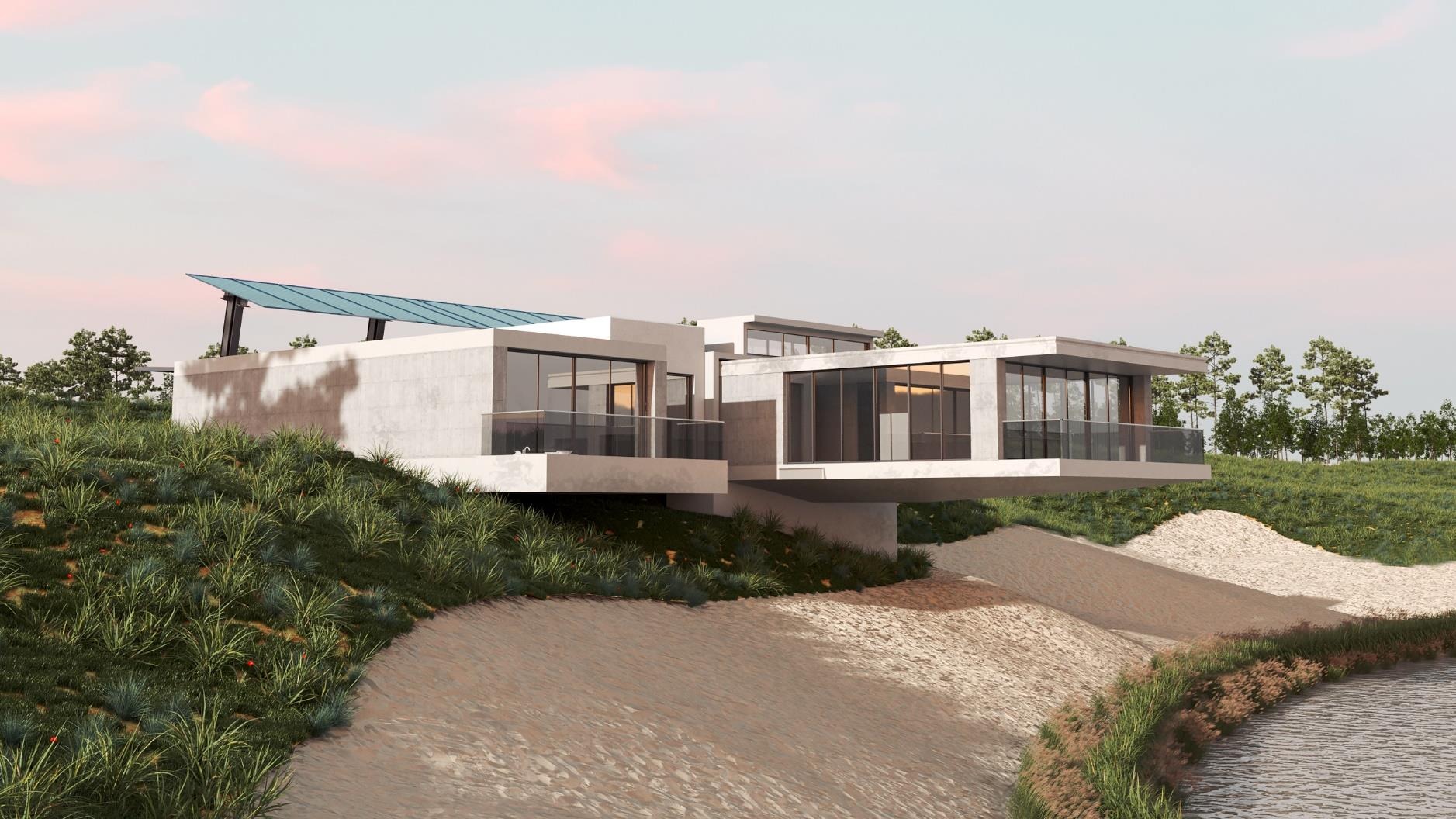 Nowoczesny dom z betonu architektonicznego na wzgórzu, z dużymi przeszkleniami i balkonem z szklaną balustradą, oświetlony popołudniowym słońcem.