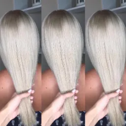 Efekt koloryzacji sombre na długich, platynowych włosach, prezentowany w salonie w Łodzi; widoczne przejście od ciemniejszego odrostu do jasnych końcówek.