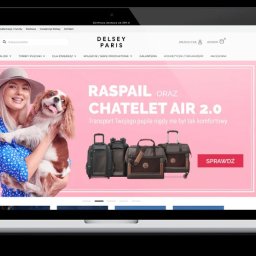 TRUST DEAL - Responsywna strona internetowa Delsey Paris na laptopie i smartfonie. Kobieta z psem, walizki, torby. Darmowa dostawa. Estetyczny design, czytelna nawigacja.