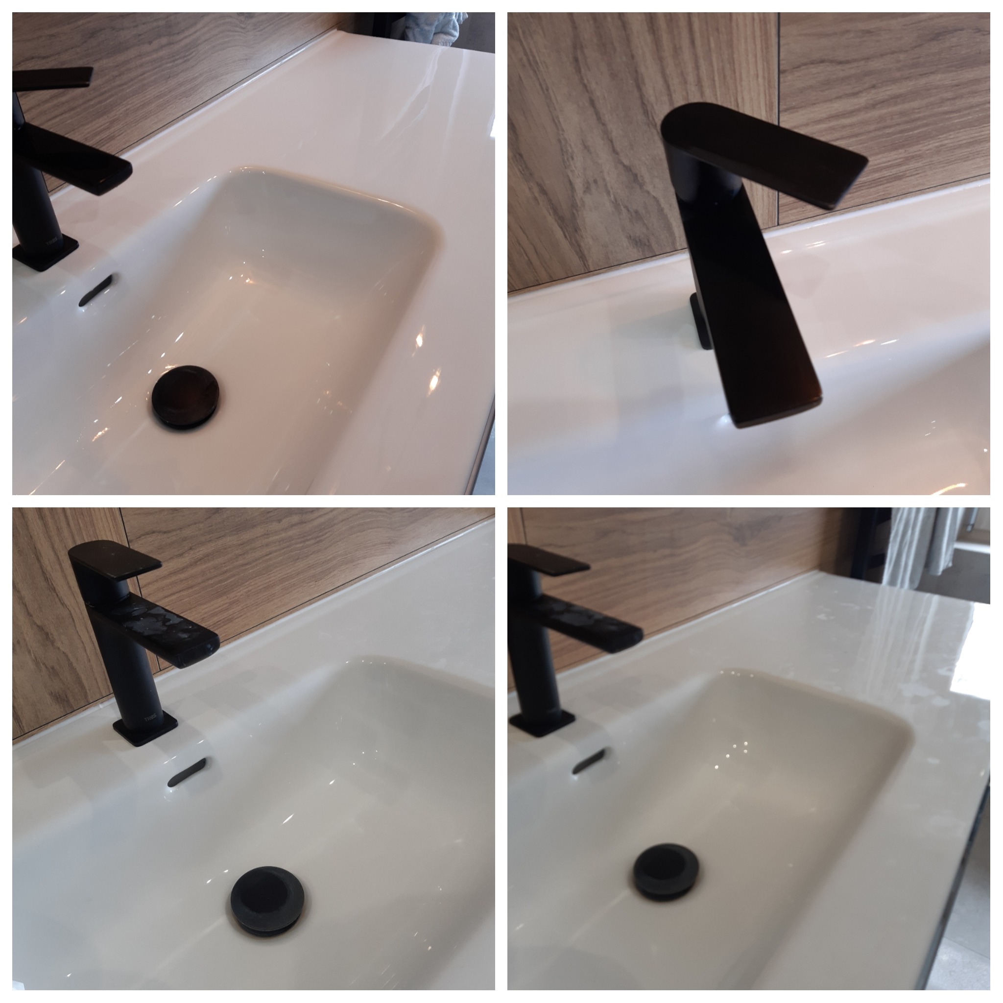Biała umywalka z czarną armaturą i korkiem, zamontowana na blacie z imitacją drewna.