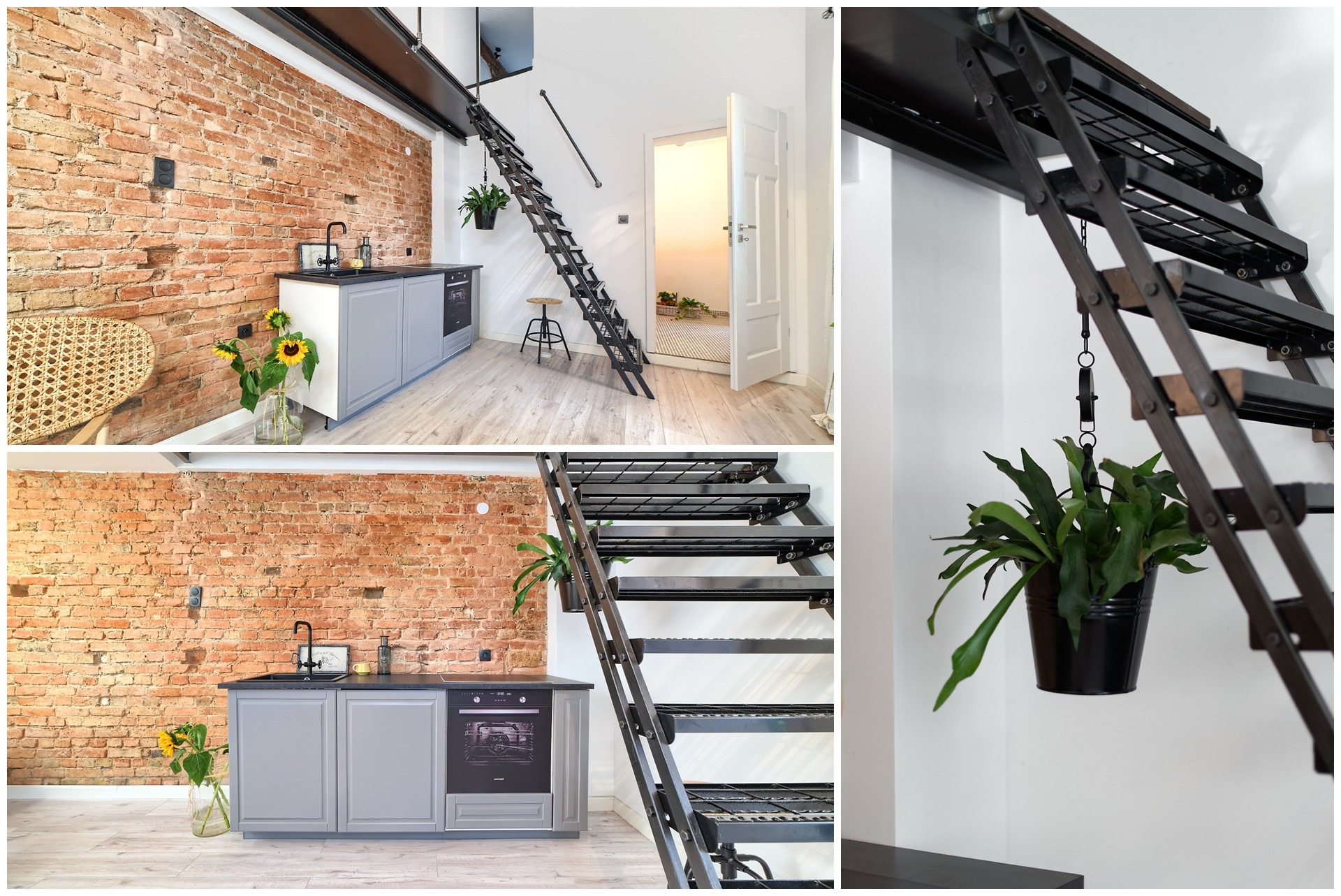 Loftowe mieszkanie z ceglaną ścianą, szarą zabudową kuchenną, metalowymi schodami drabinkowymi prowadzącymi na antresolę i otwartymi drzwiami do jasnego pomieszczenia.