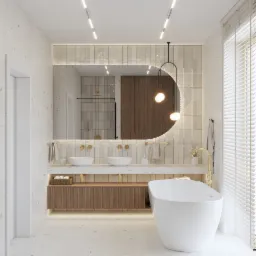 Elegancka łazienka z owalnym lustrem podświetlonym LED, dwiema umywalkami i wolnostojącą wanną. Beżowe płytki i drewniane szafki dodają ciepła. Nowoczesny design.