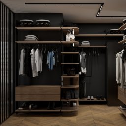 Sirocco Studio Jakub Łaski - Nowoczesna garderoba w ciemnej tonacji z drewnianymi elementami. Ubrania wiszą na wieszakach, a na półkach leżą poskładane tekstylia i torebki. Całość oświetlona ledami.