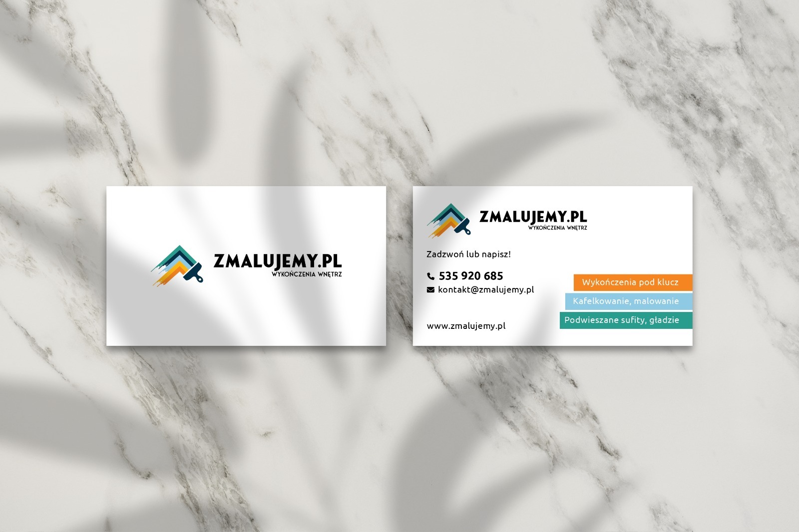 Dwie wizytówki firmy wykończeniowej ZMALUJEMY.PL na marmurowym tle, z logo przedstawiającym pędzel i informacje kontaktowe: numer telefonu, adres e-mail i strona internetowa. Usługi: wykończenia...