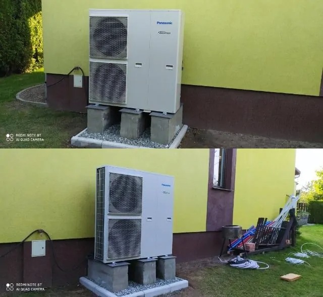 Zewnętrzna jednostka pompy ciepła Panasonic Inverter, zamontowana na betonowych podstawach z szarym żwirem, przy żółtej ścianie budynku z brązowym cokołem. Widoczne przewody i elementy instalacyjne...