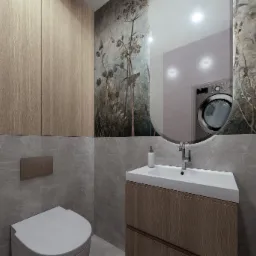 Nowoczesna łazienka w szarościach z drewnianymi akcentami. Umywalka z szafką, toaleta, szafki wiszące i lustro z odbiciem pralki. Na ścianie tapeta w motywy roślinne.