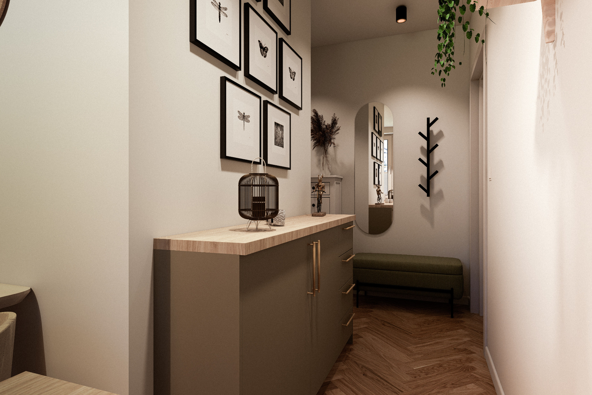 Nowoczesny przedpokój z komodą w kolorze khaki, dekoracjami i lustrem w owalnej ramie. Na ścianie grafiki w czarnych ramkach i wieszak na ubrania.