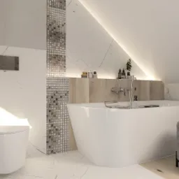 Jasna łazienka na poddaszu z wanną wolnostojącą, toaletą, grzejnikiem drabinkowym i mozaiką na ścianie, oświetlenie LED pod skosem dachu.