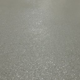 Mazur Vitalii - Świeżo wylana, jasnoszara posadzka z widoczną strukturą, odbijająca światło, z fragmentem ściany i słupa w tle.