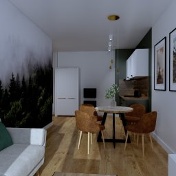 KS PROJECT Sp. z o.o. - Wizualizacja wnętrza mieszkania inwestycyjnego z tapetą w leśny motyw, okrągłym stołem jadalnym z czterema brązowymi krzesłami i aneksem kuchennym w tle.