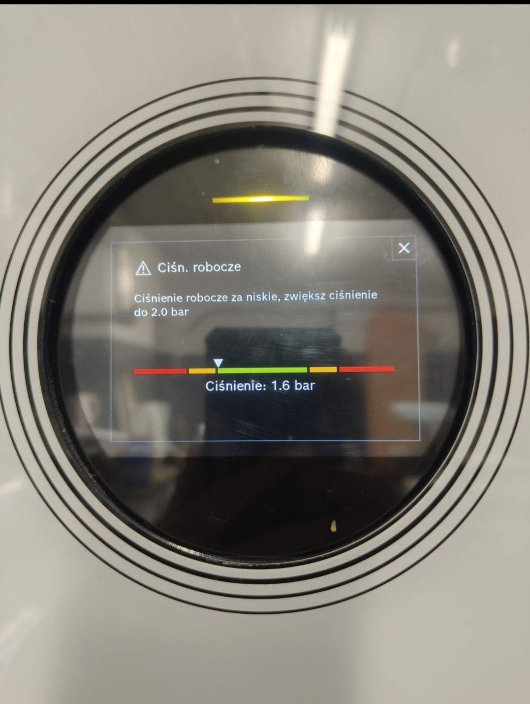 Wyświetlacz urządzenia z informacją o niskim ciśnieniu roboczym (1.6 bar). Komunikat: zwiększ ciśnienie do 2.0 bar. Widoczny alert 'Ciśn. robocze'.