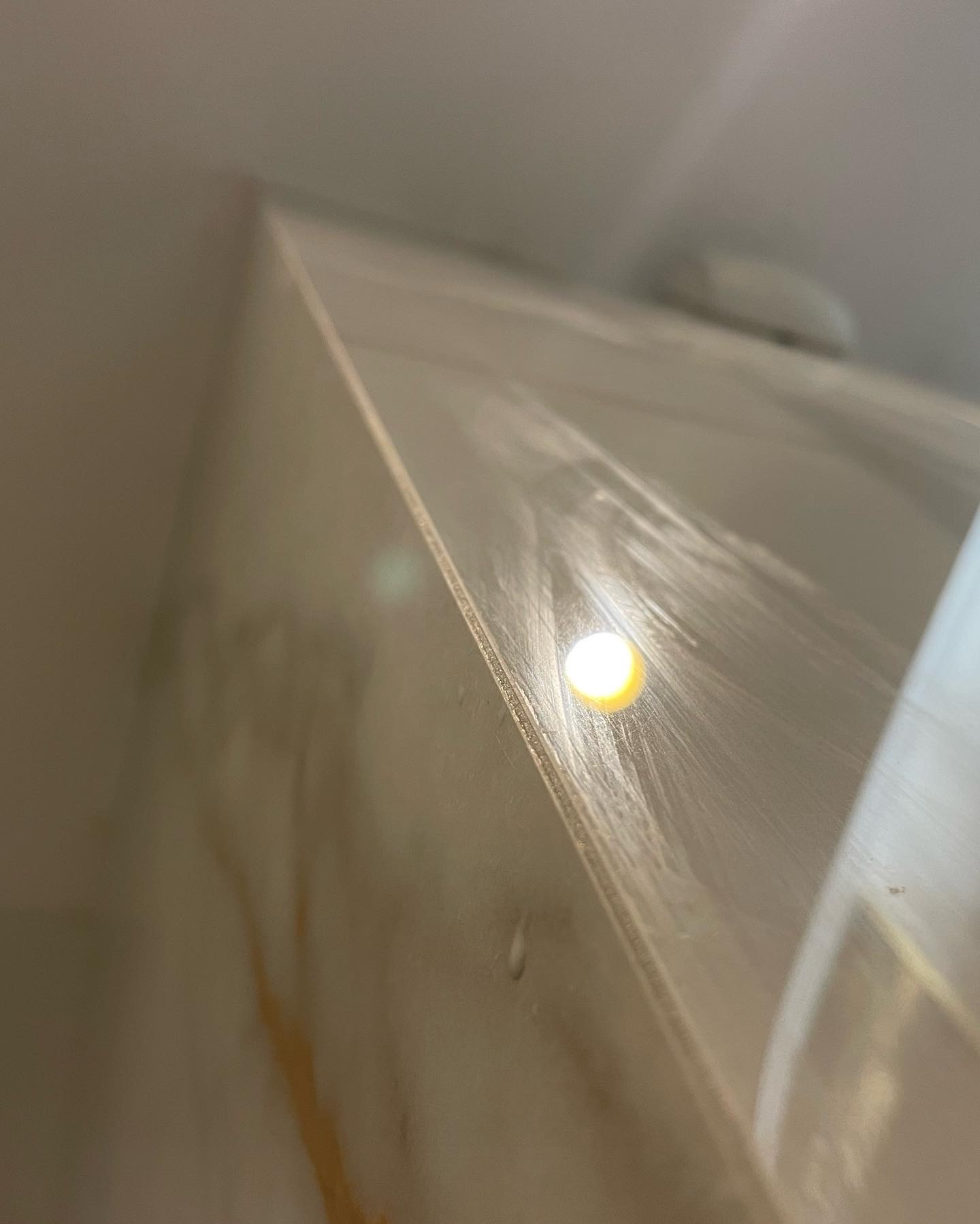 Świeżo położona gładź na suficie, widoczna faktura i odbicie światła punktowego