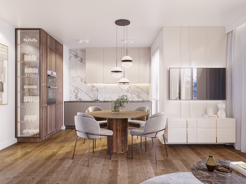 Wizualizacja jadalni w jasnych barwach z okrągłym stołem, krzesłami na metalowych nogach, wiszącymi lampami kulami i zabudową kuchenną z marmurowym blatem oraz wysoką witryną z oświetleniem...