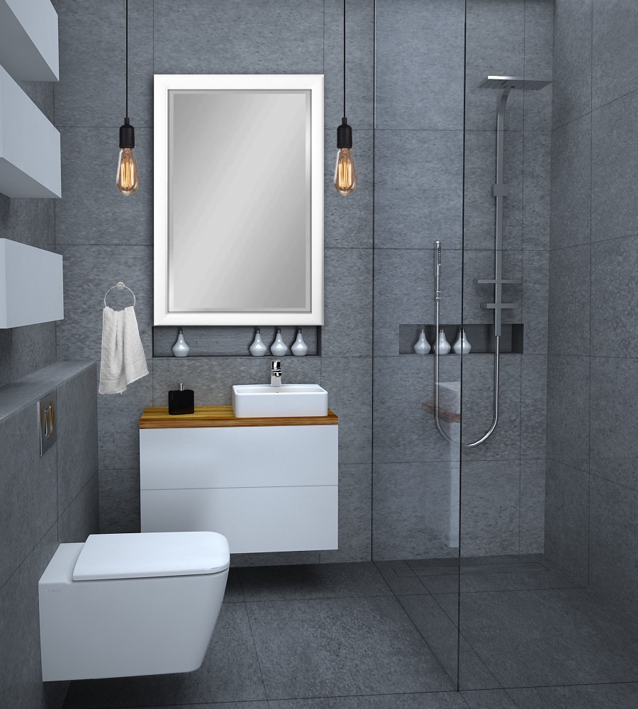 Nowoczesna łazienka z szarymi płytkami, białymi meblami, umywalką nablatową, wiszącą toaletą i szklaną kabiną prysznicową, oświetlona żarówkami Edisona.