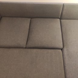 CzystoVit - Szary narożnik z wysuwanym siedziskiem, widok z góry, prezentujący fakturę tkaniny obiciowej.