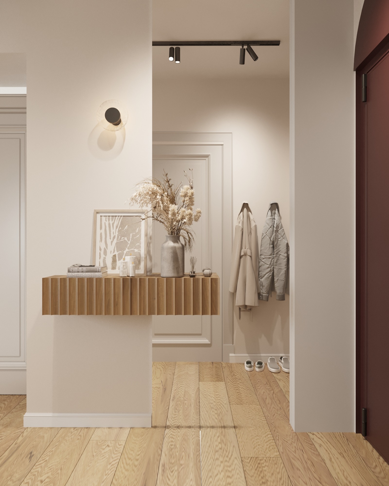 Nowoczesny przedpokój z drewnianą konsolą, dekoracjami, oświetleniem punktowym i wieszakami na płaszcze w stonowanej kolorystyce.