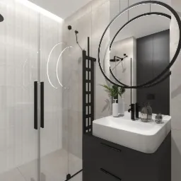 Nowoczesna łazienka z kabiną prysznicową ze szklanymi drzwiami, umywalką nablatową na czarnej szafce, okrągłym lustrem z podświetleniem LED i czarną armaturą.