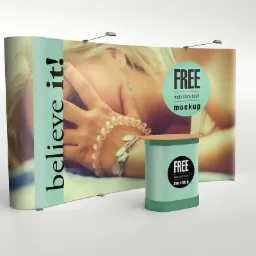 Stoisko targowe z grafiką kobiety i napisem 'believe it!' oraz ladą promocyjną z napisem 'FREE trade show booth mockup'.
