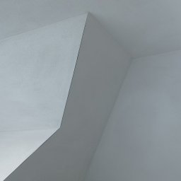 USŁUGI TYNKARSKO-BUDOWLANE - Wnętrze poddasza po świeżo wykonanych pracach wykończeniowych, widoczne gładkie, białe ściany i sufit z nietypowymi skosami i załamaniami, delikatne światło wpadające przez okno po lewej stronie.