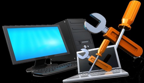 Komputer stacjonarny z monitorem, laptop oraz narzędzia: klucze i śrubokręty na czarnym tle.