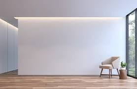 Minimalistyczne wnętrze w Sieniawie: gładka, biała ściana z subtelnym oświetleniem LED, drewniana podłoga i fotel w rogu. Nowoczesny design, jasne kolory.