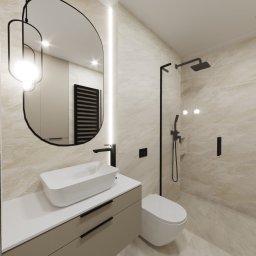 Studio Vermilion Anna Cisło - Nowoczesna łazienka w beżowych odcieniach z owalnym lustrem podświetlonym LED, białą umywalką nablatową na szafce z szufladami, czarną armaturą i kabiną prysznicową typu walk-in.