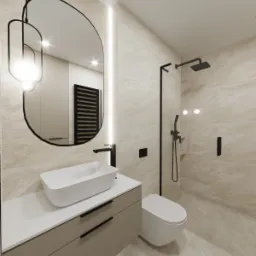 Nowoczesna łazienka w beżowych odcieniach z owalnym lustrem podświetlonym LED, białą umywalką nablatową na szafce z szufladami, czarną armaturą i kabiną prysznicową typu walk-in.