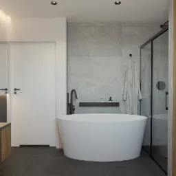 Nowoczesna łazienka z wolnostojącą białą wanną, czarną armaturą i szarymi płytkami imitującymi kamień, uzupełniona o minimalistyczną półkę z kosmetykami i szklaną kabinę prysznicową.