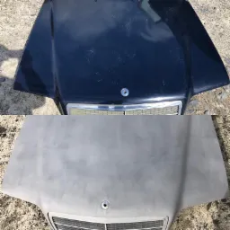 Dwa samochodowe błotniki: górny, ciemny, zarysowany, i dolny, szary, po obróbce przygotowawczej.