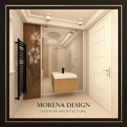 Morena Design - Wizualizacja łazienki z kabiną prysznicową za szkłem, umywalką na szafce z jasnego drewna i grzejnikiem drabinkowym. Na ścianie dekoracja z motywem kwiatowym.