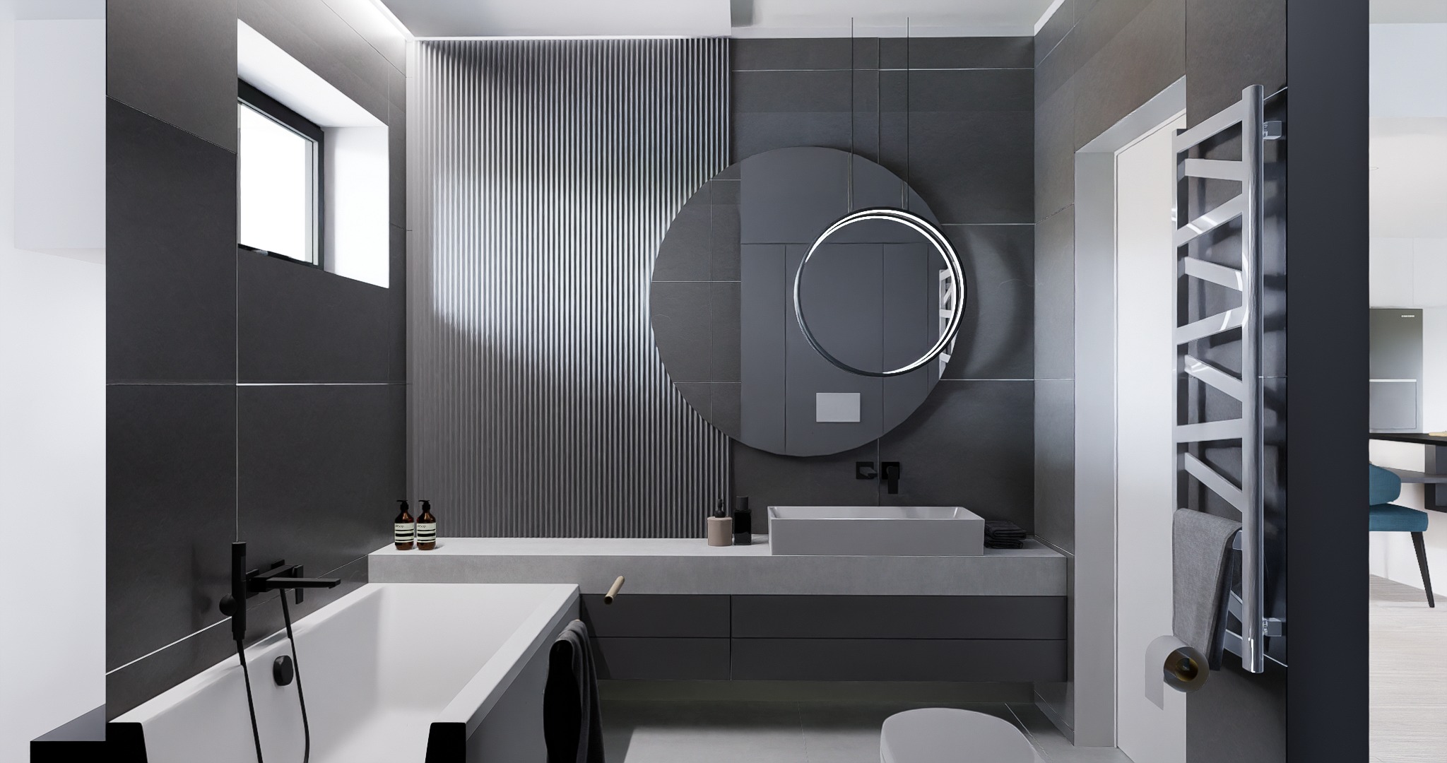Nowoczesna łazienka w odcieniach szarości z okrągłym lustrem z podświetleniem LED, grzejnikiem drabinkowym i minimalistyczną armaturą.