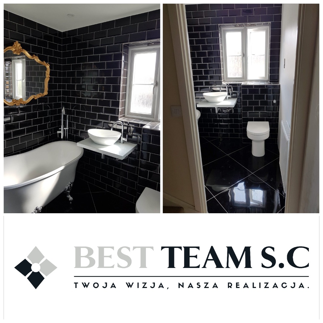 Wykończona łazienka z czarnymi płytkami, białą wanną na nóżkach, umywalką nablatową na białej półce i złotym lustrem w ozdobnej ramie. Widoczny również fragment toalety i grzejnika. Na dole logo...