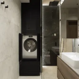 Nowoczesna łazienka z pralką ukrytą w czarnej, perforowanej zabudowie, marmurowy prysznic typu walk-in i prostokątna umywalka na drewnianej szafce.